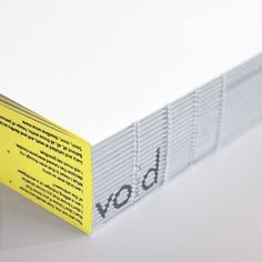 a white book with yellow label on it