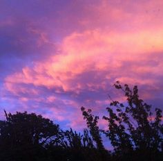 the sky is pink and purple with some clouds