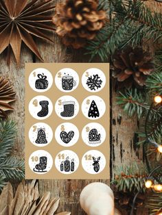 christmas stickers on a wooden table with pine cones