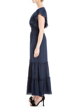 Lightweight fabric is shaped into this flowy crepe maxi dress designed with tiers of ruffles and smocked detailing. Surplice V-neck Short flutter sleeves 97% polyester, 3% spandex Machine wash cold, line dry Imported Model stats: 5'10", 32" bust, 25" waist, 36" hip. Model is wearing size Small. Chic Maxi Dress With Ruffle Hem And Flutter Sleeves, Chic Flowy Ruffled Maxi Dress, Chic Flowy Maxi Dress With Ruffles, Flowy Midi Dress With Ruffle Hem And Straps, Chic Maxi Dress With Smocked Back And Flowy Skirt, Flowy Midi Dress With Ruffle Hem And Ruffled Straps, Flowy Ruffle Sleeve Tiered Vacation Dress, Ruched Flowy Maxi Dress, Flowy Tiered Dress With Ruffle Sleeves For Vacation