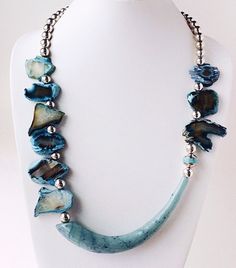 This blue agate and glass horn necklace is quite a change for me in terms of design! Most of my necklaces are symmetrical and this statement piece is striking in the asymmetrical placement of the beads and horn. I found this Agua glass horn at a show a year ago and never found beads to use with it until now! I love the contrast between the organic blues and the smooth surface of the glass. Sterling Silver round beads add the elegance and pull the design together. The toggle clasp has a hammered Organic Necklace, Silver Beaded Necklace, Fan Necklace, Unique Jewelry Gifts, Organic Jewelry, Horn Necklace, Silver Necklace Statement, Silver Bead Necklace, Gemstone Beaded Necklace