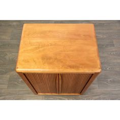 a small wooden cabinet sitting on top of a hard wood floor