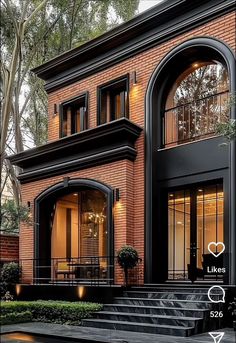 a large brick house with arched windows and stairs