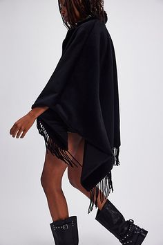 The perfect blend of cool and classic, this timeless poncho is featured in a stunning wool blend fabrication with leather-inspired collar, stud detailing, and defined fringe at bottom trim for added dimension. **Features:** Relaxed fit, leather-inspired collar, stud detailing, fringe detailing at bottom hem **Why We ❤ It:** The loveliest layer to add a cool factor to absolutely any outfit. | Understaded Leather Poncho Jacket by Understated Leather at Free People in Black Leather Poncho Women, Leather Poncho, Brown One Size Poncho With Fringe, Oversized Fringe Cape Poncho, Black Fringe Poncho Shawl, Casual One-size Poncho With Fringe, Poncho Jacket, Wool Blend, Free People