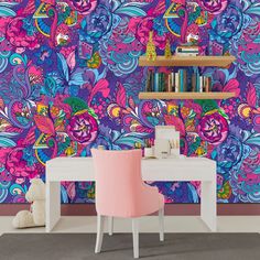 a colorful wallpapered room with a desk and chair