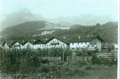 an old black and white photo of houses in the mountains