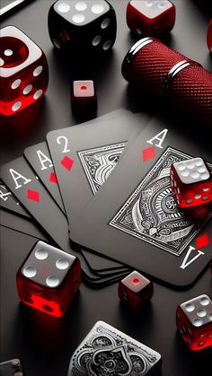 red and black playing cards with dices, pens, and other items on a table