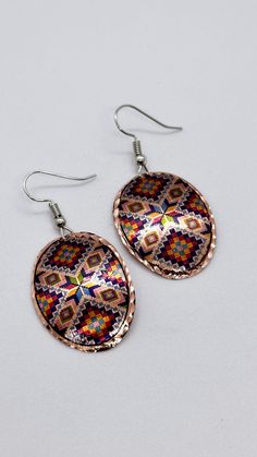 Elevate your style with these Handmade Oval Patterned Copper Earrings. Each pair is meticulously crafted from pure copper with an intricate oval design that exudes both elegance and rustic charm. Perfect for those who love unique, artisanal jewelry, these earrings are lightweight and versatile, making them suitable for any occasion. Whether you're dressing up a casual look or complementing formal wear, these copper earrings are sure to turn heads. They also make an ideal gift for any woman who a Artisan Oval Earrings As A Gift, Artisan Oval Earrings For Gifts, Bohemian Oval Earrings For Gift, Artisan Oval Earrings For Pierced Ears, Multicolor Oval Earrings For Gift, Bohemian Handmade Oval Earrings, Artisan Oval Earrings With Ear Wire, Handmade Bohemian Oval Earrings, Bohemian Oval Metal Earrings