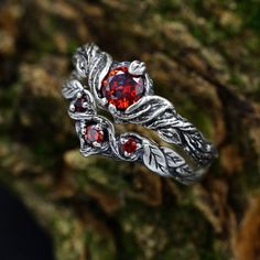 Crafted from sterling silver, this set features a nature-inspired design that encapsulates the spirit of the forest. The dainty silver leaves and unique garnet stones make this set a perfect choice for a woman who appreciates the delicate beauty of the natural world.  Characteristics: Metal - Recycled solid sterling silver  Stone - Cubic Zirconia Finish - Oxidized. View all silver nature wedding ring sets: https://www.etsy.com/shop/TinyShinyJewel?ref=seller-platform-mcnav&section_id=45348609 Care instructions: To care for the ring, avoid contact with water and chemicals such as perfumes and lotions. When the ring is not in use, store it in a dry, cool place to prevent tarnishing. Additional information:  ✦ All rings are made to order. An average turnaround time is 1-5 days. I will make eve Silver Ethereal Jewelry With Birthstone, Fantasy Sterling Silver Jewelry For Anniversary, Ethereal Sterling Silver Wedding Rings, Silver Nature-inspired Wedding Jewelry, Ethereal Silver Ring For Gift, Handmade Fantasy Wedding Rings, Silver Birthstone Jewelry With Magical Style, Elegant Silver Jewelry For Fantasy Events, Nature-inspired Silver Wedding Jewelry