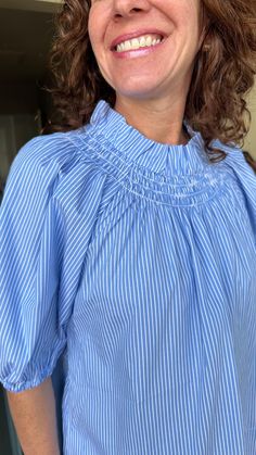 The Brooke Top in Blue Stripe is perfect for spring! Featuring a smocked neck, puff sleeves with an elastic elbow, and a flowy bodice, the Brooke Top remains a tried and true style! One size fits a 4-12 best. 100% cotton. Machine wash gentle cycle, hang to dry. Cathleen is 5'4" and usually wears a small (2/4) in tops. Elegant Spring Smocked Top With Elastic Neckline, Spring Smocked Lantern Sleeve Top With Elastic Sleeves, Blue Blouse With Ruffled Collar For Daywear, Spring Balloon Sleeve Smocked Top, Spring Smocked Top With Balloon Sleeves, Spring Billowy Smocked Top, Spring Balloon Sleeve Blouse With Smocked Back, Spring Balloon Sleeve Smocked Top With Smocked Back, Spring Smocked Back Balloon Sleeve Top