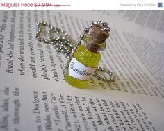 a small bottle with a corked top sitting on an open page of a book