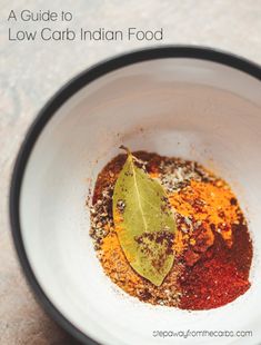 a white bowl filled with spices on top of a table