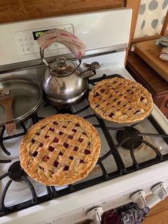 two pies are sitting on top of the stove