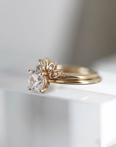 a gold ring with a white diamond on it