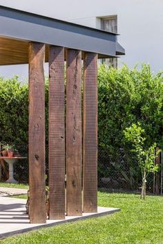 a wooden structure sitting on top of a lush green field