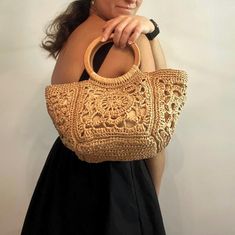 Crocheted Raffia Bag, Raffia Handbag, Natural Wooden Handle Handbag, Handmade Bag, Crochet Bag Making, Motif Bag, Granny Square Bag This handmade bag, with its handle made of natural wood and motifs knitted with raffia thread, will give you a stylish look. You can combine this bag with both your daily clothes and your stylish clothes. Each bag is knitted with care and love. I would like to point out that it is so special and unique that it cannot be compared with other mass-produced products.  If you want to buy this handmade bag as a gift, it will be a truly special gift. Product features: Color is Tan Brown. It is lined and has one interior pocket. There are closing devices. Height with handle: 29 cm ( 11.5 inches ) Height without handle: 19 cm ( 7.5 inches ) Width: 17.5 cm ( 7 inches ) Beige Crochet Bag With Round Handle For Shopping, Crochet Handheld Bag With Detachable Handle For Daily Use, Natural Crochet Bag With Round Handle, Beige Crochet Bag With Handles, Natural Crochet Bag With Round Handle For Shopping, Bohemian Shoulder Bag With Round Handle, Natural Straw Pouch Bag With Detachable Handle, Natural Crochet Bag For Daily Use, Natural Pouch Straw Bag With Detachable Handle