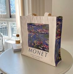 "Claude Monet French Oil Painter \"Water Lilies - Morning, 1914\" Aesthetic Canvas Tote Bag with Zip Closure & Inner Pocket Book tote bag - Tote bag books - Aesthetic tote bag - Aesthetic art tote - Aesthetic art bag - Tote bag with zip - Tote with zipper - Tote with pocket - Shoulder bags - Canvas tote bag - Museum lover bag - Museum tote bag - Environmentally friendly tote bag - Aesthetic handbag - Gifts for Book Lovers - Gifts for Her - Gift for Art Lovers About the art:  Claude Monet's painting titled \"Water Lilies - Morning\" is one of the most famous works of the famous French Impressionist artist. This masterpiece is a part of a series of oil paintings that Monet created of his water lily pond. It is particularly famous for its tranquil, yet vibrant use of colors and its dream-like 1914 Aesthetic, Claude Monet Outfit, Claude Monet Inspired Fashion, Aesthetic Canvas Art, Artistic Tote Bag For School, Tote Aesthetic, Claude Monet Phone Case, Aesthetic Canvas, Monet Tote Bag