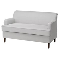 a white couch sitting on top of a wooden floor