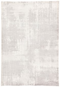 an area rug with white and gray colors on the floor, in front of a white background