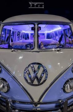 an old vw bus is parked on display