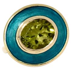 Rooted in clean, classic lines, this bold yet elegant ring reflects the individuality of the wearer. The crisp green Peridot glistens next to the turquoise vitreous hot enamel, transporting us back to a tropical island ocean. Peridot one of the oldest mined stones from as early as 1500 BC is packed with positive energy giving the wearer a sense of well being like a sun kissed summer day. Celebrating my love for colour and the venerable technique of enameling I am so pleased to present my signatu Elegant Green Enamel Ring With Polished Finish, Green Enamel Ring For Formal Occasions, Elegant Green Enamel Ring, Elegant Green Oval Enamel Ring, Formal Green Enamel Ring With Polished Finish, Classic Green Enamel Jewelry, Formal Green Enamel Jewelry, Elegant Green Enamel Gemstone Ring, Green Oval Enamel Ring For Anniversary