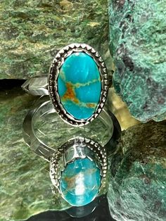 This beautiful Royston Turquoise stone shows shades of blue and brown. The stone was wrapped in a fine silver scalloped bezel. Around the base you'll find Sterling half bead. The band is Sterling triangle withouts around the outside of the band. The setting for the stone measures 17.93 by 13.31mm wide. Bohemian Adjustable Stackable Turquoise Ring, Adjustable Stackable Bohemian Turquoise Ring, Bohemian Stackable Blue Turquoise Ring, Bohemian Blue Stackable Turquoise Ring, Bohemian Stackable Turquoise Ring, Southwestern Turquoise Ring With Natural Stones, Southwestern Style Jewelry With Oval Natural Stones, Southwestern Oval Natural Stones Jewelry, Unique Stackable Turquoise Ring