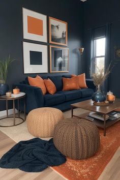 a living room with blue walls and orange pillows on the couches in front of them