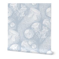 a blue and white wallpaper with jellyfish on it