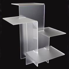 three clear shelves stacked on top of each other in front of a black background,