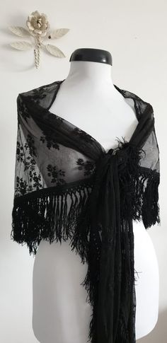 "Vintage 1930s black lace shawl with floral embroidery and black fringe. ....M E A S U R E M E N T.... 101\" in full width 25\" from center of straight edge to tip of fringe 4\" fringe brand/maker: n/a condition; excellent( see last photo ) Shipping Is Avaliable Worldwide. Every item is carefully shipped Priority via Air Mail - shipping takes from 7 to 14 working days, depending on your location. Shipping includes Tracking. Come and check out our shop to see all items! https://www.etsy.com/shop/ Black Ruffled Shawls, Black Lace Shawl Weddings, Luxury Black Bohemian Shawl, Cheap Vintage Shawl, Crochet Lace Shawl Black, Black Rose Shawl, Victorian Shawl 19th Century, 1930s Gothic Fashion, Black Lace Shawl