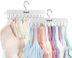 an assortment of bras hanging from hooks on clothes pins and hangers with clips