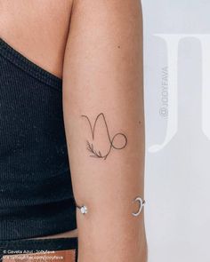 a woman's arm with a tattoo on the left side of her arm and a crescent