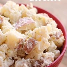 a white bowl filled with potatoes on top of a table