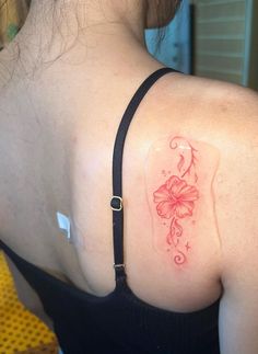 a woman with a flower tattoo on her shoulder