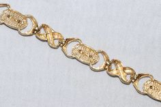 14 KT two tone gold bracelet of white and yellow featuring lions. This bracelet is measured approximately 7 inches long with lobster clasp and is weighted 9.9 grams. The bracelet is hallmarked 14 KT gold, made in Italy, and has also been checked for authenticity. Gold Link Bracelet With Clasp, Engraved Gold Metal Bracelet For Formal Occasions, Formal Engraved Gold Metal Bracelet, Lion Bracelet, Gold Lion, Marquise Ring, Staten Island, Ring Photos, Smokey Quartz