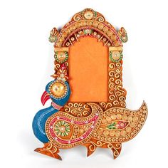 an intricately decorated wooden frame with a bird on it's back and a mirror in the middle