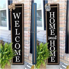 two wooden signs that say welcome home and sweet home on the side of a house