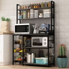 a microwave oven sitting on top of a black shelf next to a potted cactus