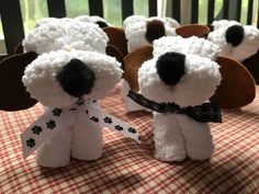 there are many stuffed dogs that are on the table with red and white checkered cloth