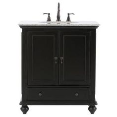 a black cabinet with two sinks and marble top