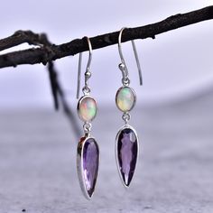 ✦ These Eye catchy luxurious Amethyst and Opal cocktail dangle earrings in sterling silver is one of a kind due to natural crystals and simple yet elegant design. These earrings are handmade with natural Amethyst and Opal, making them a truly unique and stunning piece of jewelry. The healing properties of these stones are said to promote relaxation, peace, and calmness - perfect for when you need to unwind after a long day.  Whether you're dressing up for a special occasion or just looking to ad Elegant Purple Earrings As A Gift For Her, Elegant Purple Earrings For Her, Elegant Long Drop Purple Jewelry, Elegant Purple Long Drop Jewelry, Amethyst Dangle Earrings Fine Jewelry, Fine Jewelry Amethyst Dangle Earrings, Sterling Silver Long Drop Birthstone Jewelry, Purple Long Drop Jewelry For Gift, Purple Long Drop Earrings For Gift