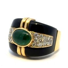 Fabulous emerald, diamond, and onyx cocktail ring handcrafted in 18 karat yellow gold. The band features a bezel set oval cabochon green emerald weighing approximately 4.00 carats, 24 round briliant cut diamonds weighing approximately 2.50 carat total weight, and onyx accent. The diamonds are graded H-I color and SI clarity. The ring measures 19.5mm in width tapering down to 6.5mm, and is currently size 8.5 (can be sized). Weight: 18.4 grams. Luxury Emerald Ring With Oval Cabochon And 17 Jewels, Luxury Oval Cabochon Emerald Ring With 17 Jewels, Fine Jewelry Green Cabochons For Formal Occasions, Green Cabochons For Formal Fine Jewelry, Luxury Oval Cabochon Emerald Ring, Elegant Green Cabochons For Formal Occasion, Luxury Green Cabochons, Elegant Cabochon Emerald Ring For Formal Occasions, Designer Oval Gemstone Rings