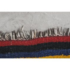 a multicolored rug with fringes on it