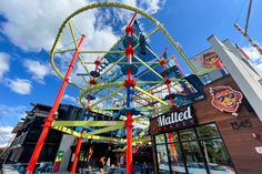 a roller coaster ride in front of a building