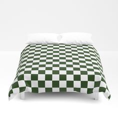 a black and white checkerboard comforter on a bed with two pillow cases