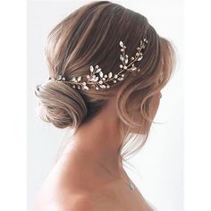 a woman wearing a bridal hair comb with leaves on it's headband