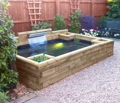 a garden with a pond in the middle and plants growing on it's sides