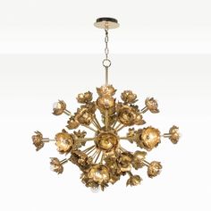 a golden chandelier hanging from the ceiling with lots of flowers on it's petals