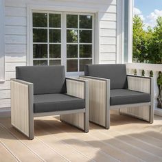 two gray chairs sitting on top of a wooden deck