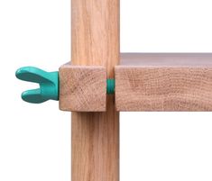 a wooden post with two green handles on it